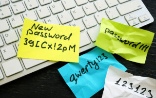 Unsichere Passwörter auf Post-it-Notizen auf einer Tastatur.